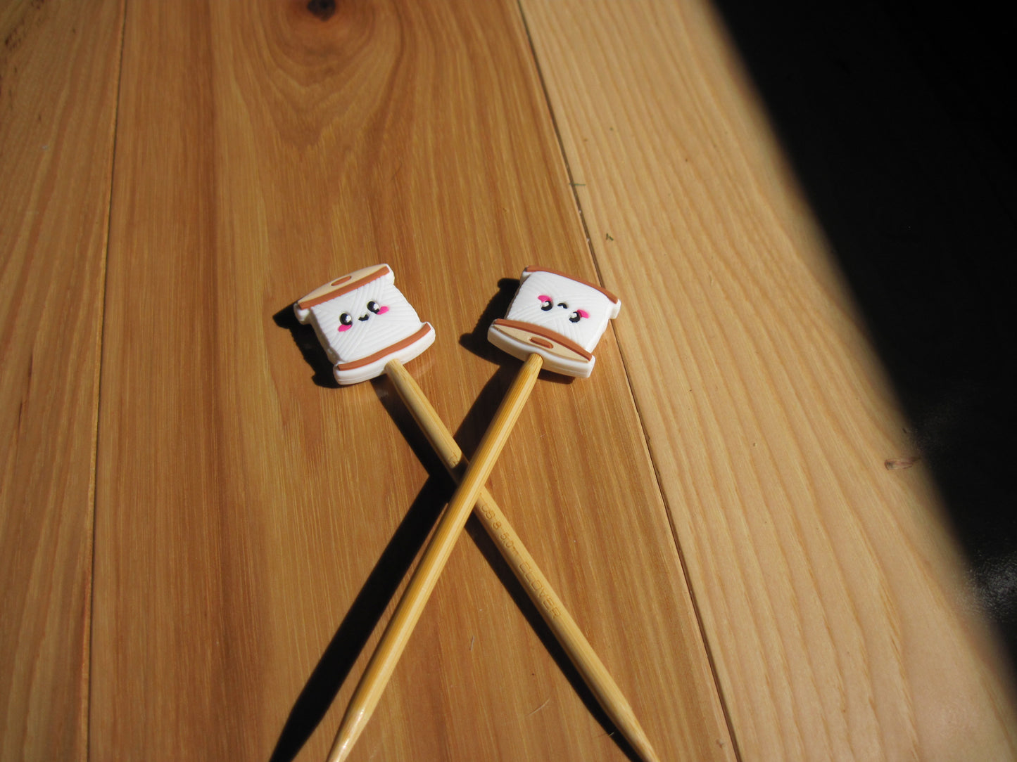 Spool of yarn stitch stoppers